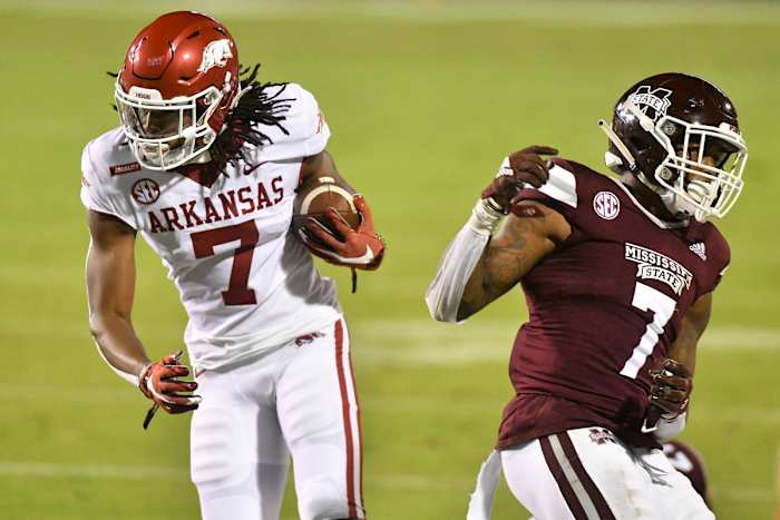 Oct 3, 2020; Starkville, Mississippi, USA; Arkansas Razorbacks wide receiver Trey Knox (7) runs the ball defended by Mississippi State Bulldogs safety Marcus Murphy (7) during the second half at Davis Wade Stadium at Scott Field. Mandatory Credit: Matt Bush-USA TODAY Sports